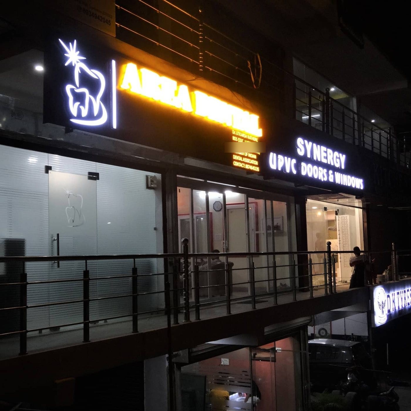 रात में लोलई रोड से दिखता एरिया डेंटल क्लिनिक का रोशन बोर्ड