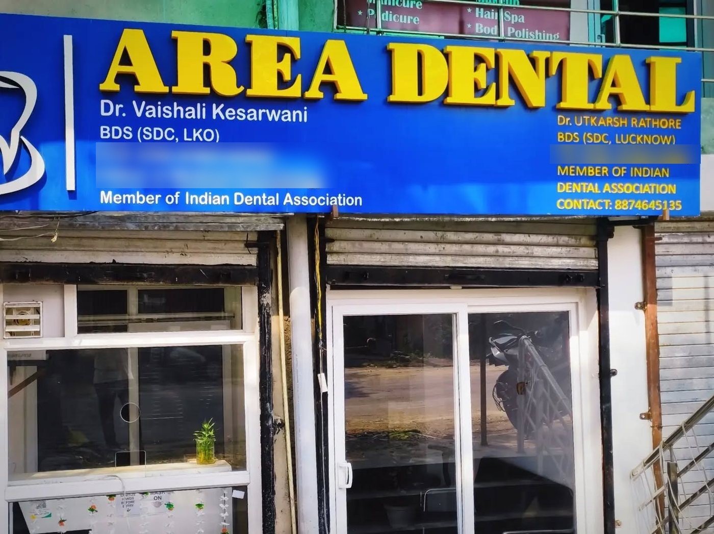 The Area Dental Clinic signboard on Lolai Road, Malhaur, listing Dr. Vaishali Kesarwani and Dr. Utkarsh Rathore